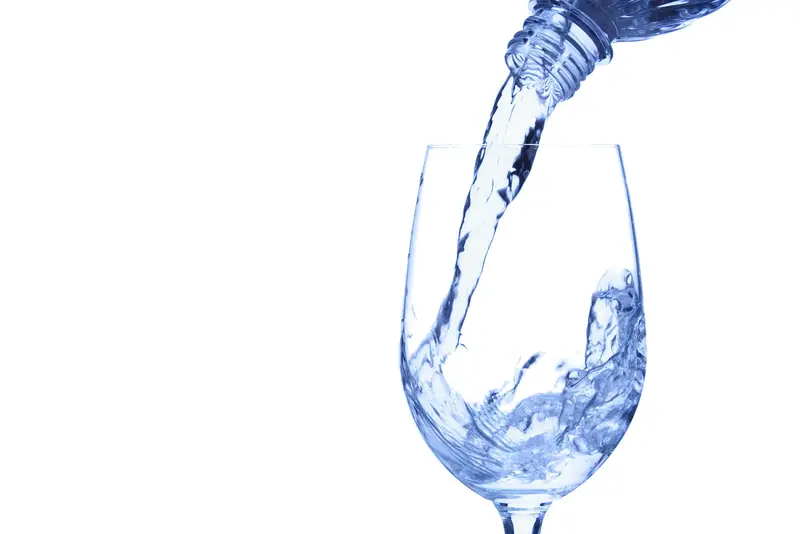 Clear drinking water being poured into a glass