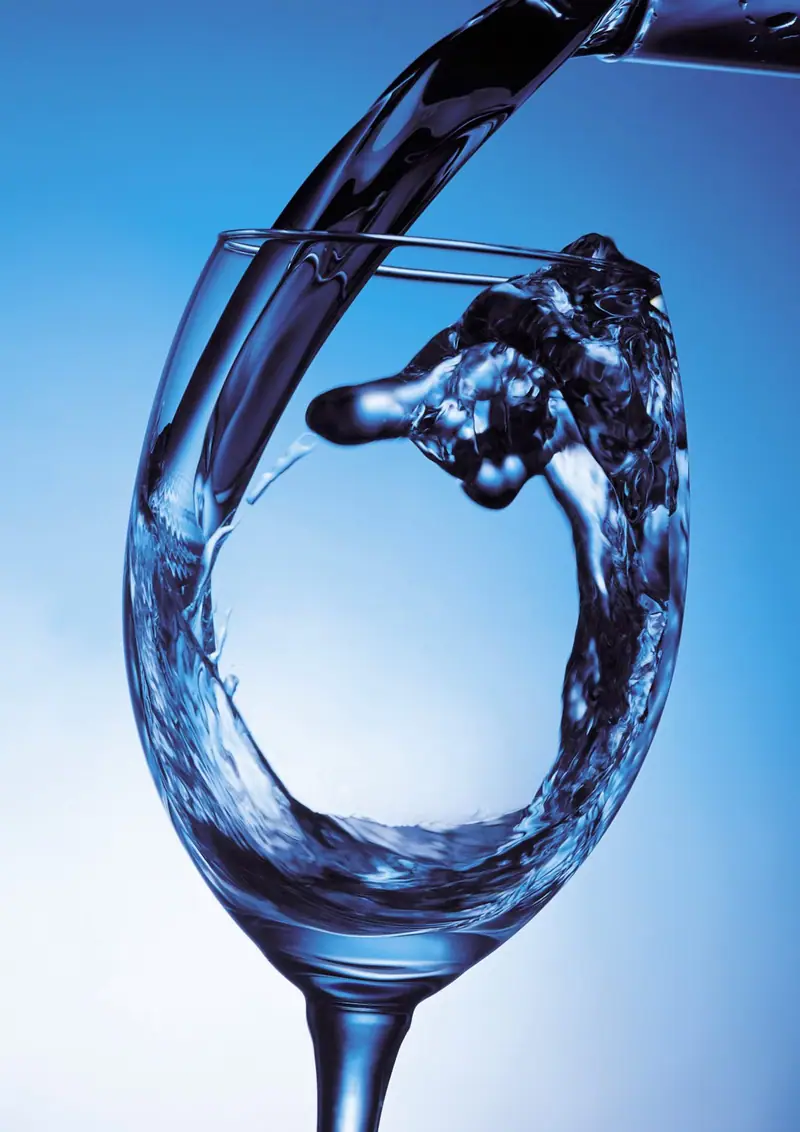 Clear water pouring into a drinking glass